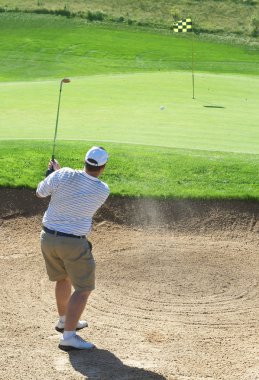 Golfer in the sand bunker clipart