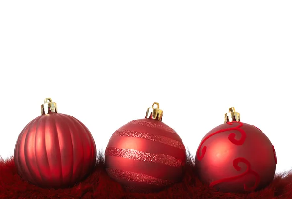 Red Christmas baubles on fur — Stock Photo, Image