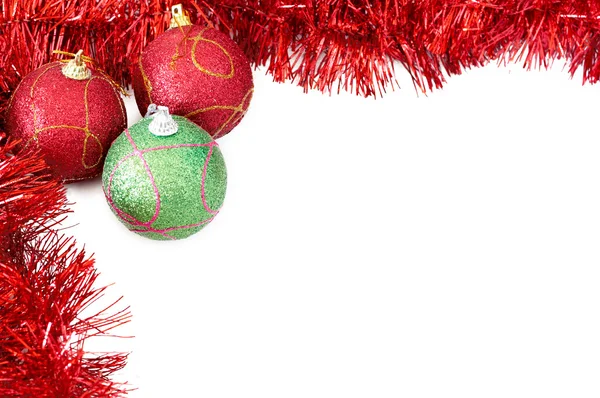 Three Christmas baubles with red tinsel — Stock Photo, Image