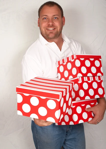 Adult Caucasian man with Christmas boxes — Stock Photo, Image