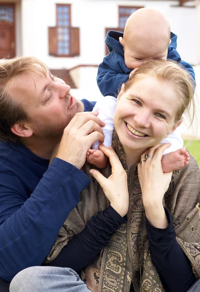 Happy family sitting on the grass — Stock Photo, Image
