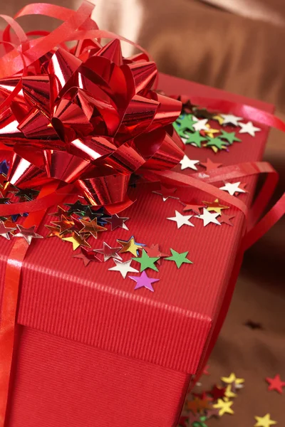 Roter Geschenkkarton mit Schleifen und Sternen — Stockfoto
