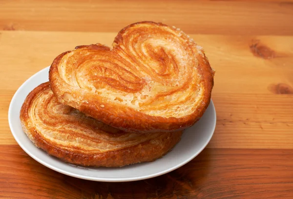 Palmier pastries on white saucer — Stock Photo, Image