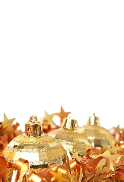 Gold Christmas baubles in tinsel — Stock Photo, Image