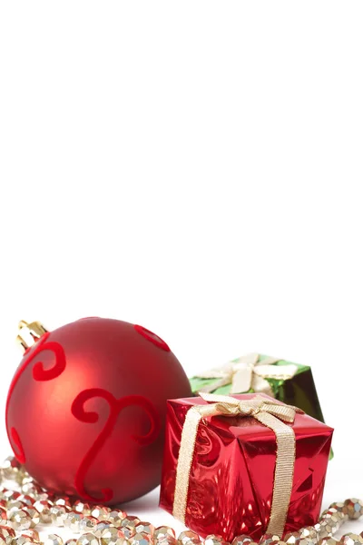 Red Christmas bauble and gifts — Stock Photo, Image