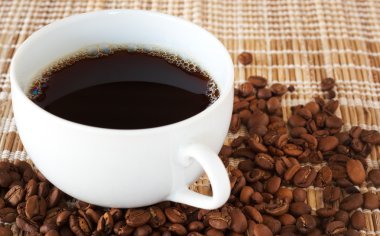 Cup of coffee with coffee beans clipart