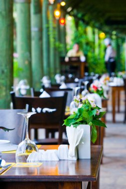 The served tables on a summer verandah clipart