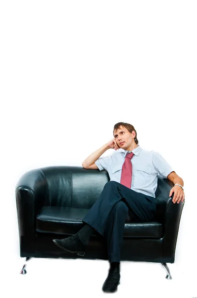De zakenman zit op een sofa — Stockfoto