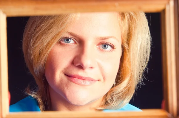 Portrait of the girl in a wooden frame — Stock Photo, Image