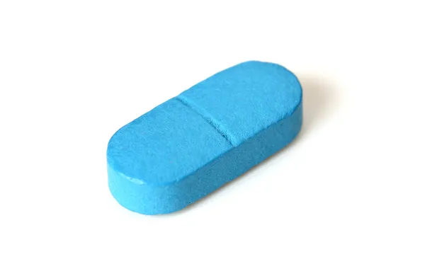Comprimido azul único isolado no branco — Fotografia de Stock