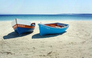 Boats on a secluded beach in South Africa clipart