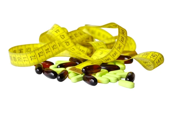 Measure tape and the capsules — Stock Photo, Image