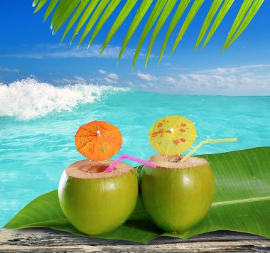 Fresh tender green coconuts straw beach cocktails clipart