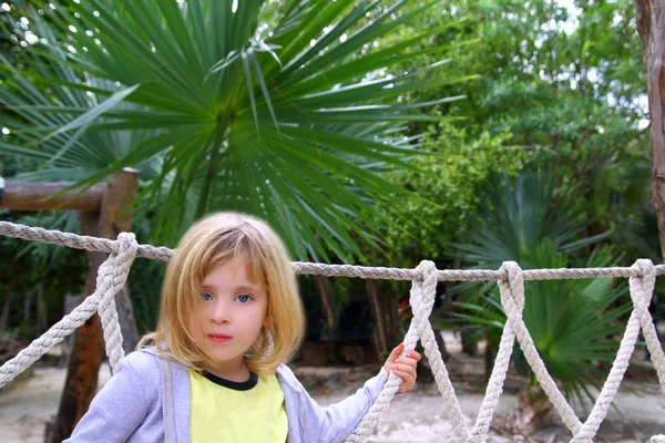 Adventure little girl on jungle park rope bridge — Stock Photo, Image