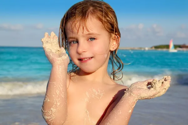 Blond little girl playing beach showing sandy hands — Stock Photo, Image