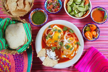 Breakfast Mexican ranchero eggs with chili and nachos clipart