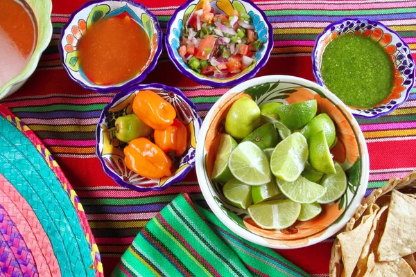 Mexican food varied chili sauces nachos lemon — Stock Photo, Image