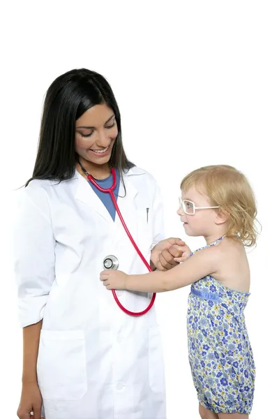 Brunette pediatric doctor with blond little girl Stock Photo