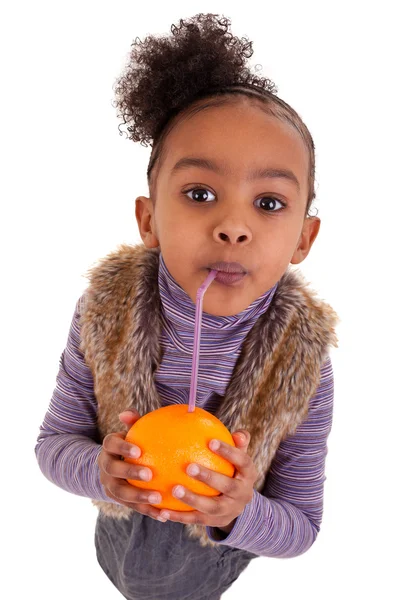 Little black girl drinking orange juice with a straw — Stock Photo, Image