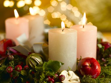 Advent wreath with a lighted candle clipart