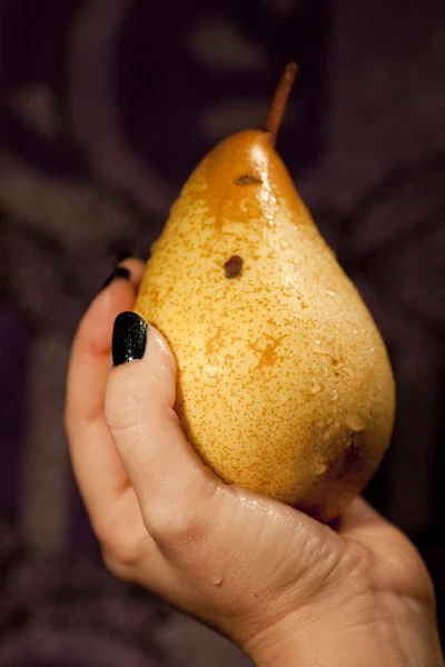 Holding a pear — Stock Photo, Image