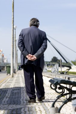 Lonely man walks on street clipart