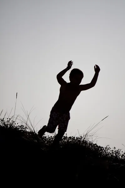 stock image Boy jumping from a dune