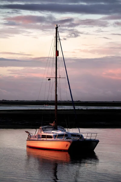 Anchored boat at sunset — Stock Photo, Image