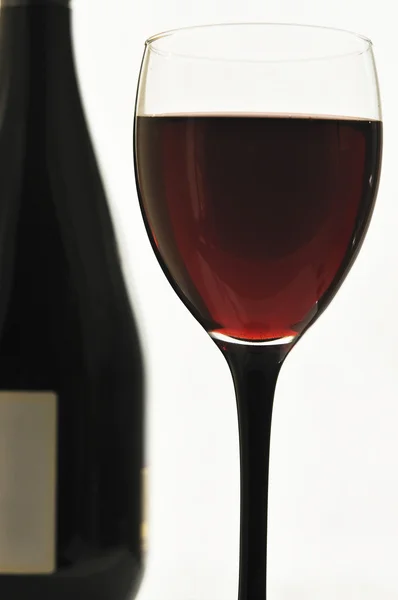 stock image Red wine in glass glasses and a bottle