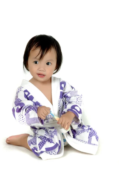 Ásia menina vestindo roupa de banho segurando uma escova de dentes — Fotografia de Stock