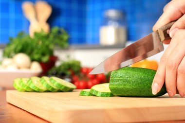 Female chopping food ingredients. clipart