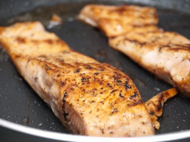 Salmon steaks on a frying pan clipart