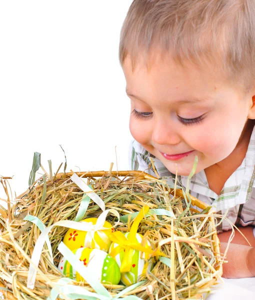 Little boy with easter eggs in basket — Stock Photo, Image