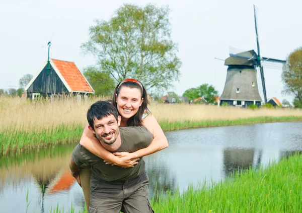 In Tulip Field. Happy young couple near Duch mills — Stock Photo, Image