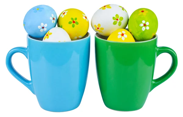Easter eggs in cups on white background — Stock Photo, Image