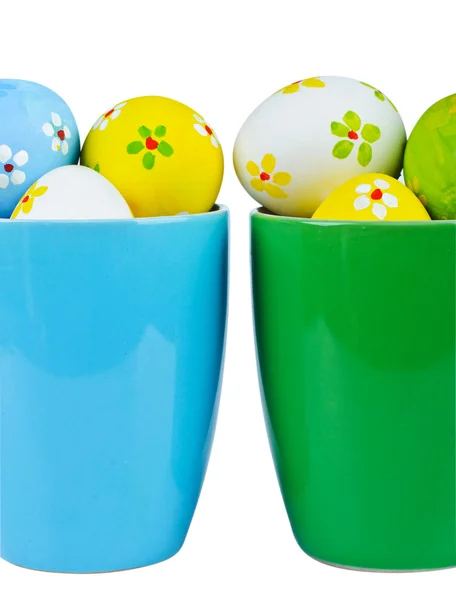 Easter eggs in cups on white background — Stock Photo, Image