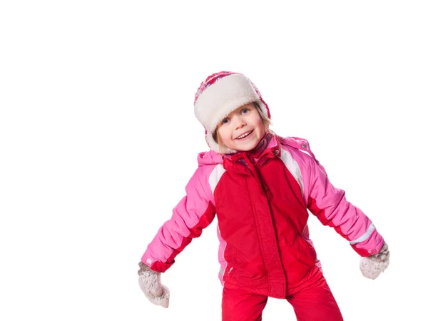 Latterjenta med røde overall og votter med snø. – stockfoto