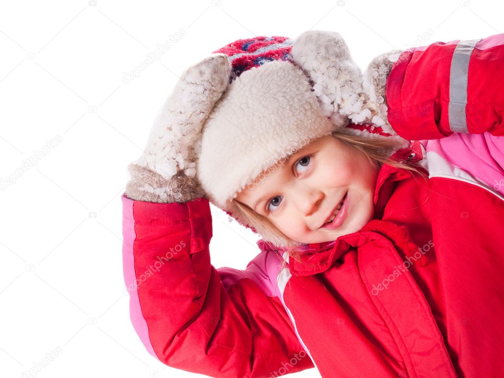 The laughing girl wearing red overalls and mittens with snow