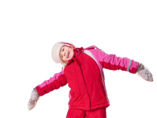 Latterjenta med røde overall og votter med snø. – stockfoto