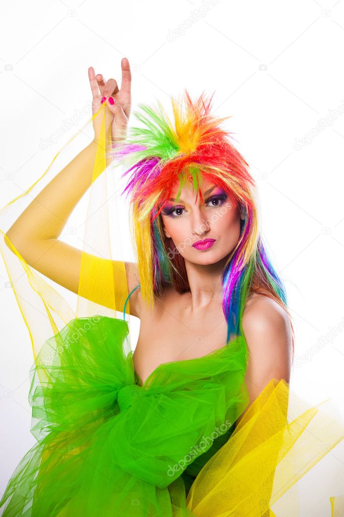 Beautiful woman with vibrant make-up wearing multicolored wig and green dre