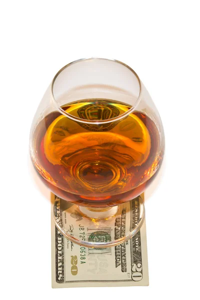 stock image Glass of alcohol with dollar