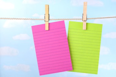Pink and green notes on clothesline clipart