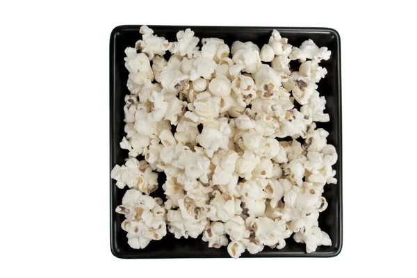 Popcorn on black plate — Stock Photo, Image