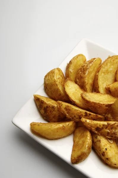 Cunhas de batata fritas — Fotografia de Stock