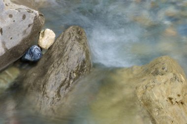 Two colored stones in a river clipart