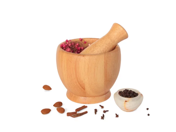 stock image Wooden pestle and mortar with some spices on white