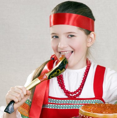 Girl licks a spoon with red caviar clipart