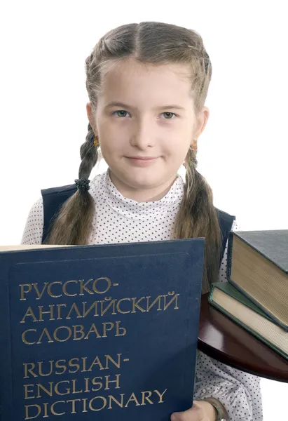 Девочка и русско-английский словарь — стоковое фото