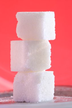 Three sugar cubes on the pink background clipart