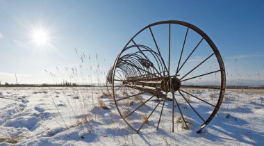 Antique hay rake in winter. clipart